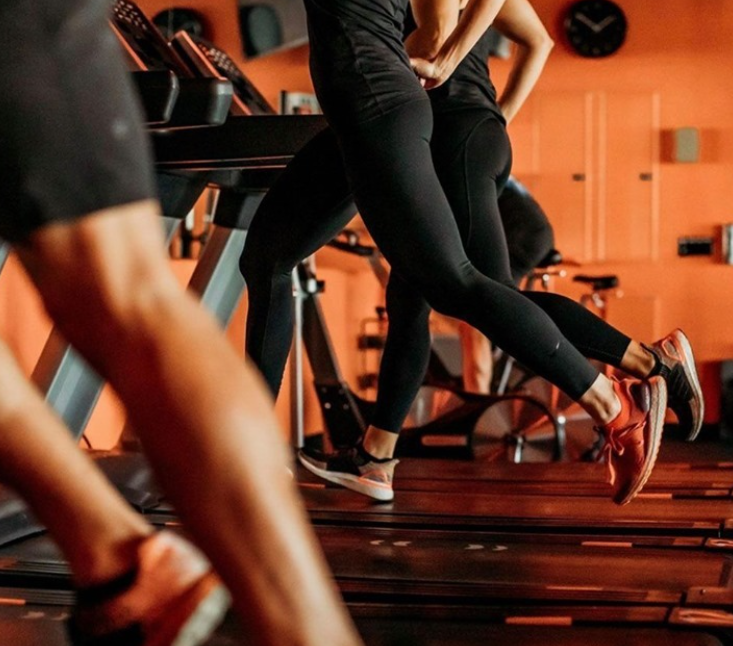 people running on Orangetheory treadmills